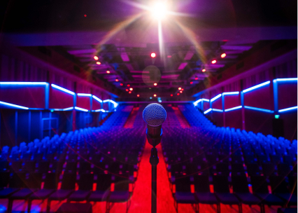 Empty theatre photographed from behind the microphone on stage