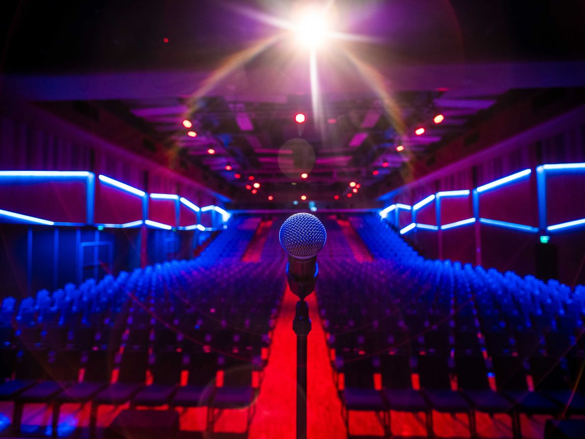 Empty theatre photographed from behind the microphone on stage